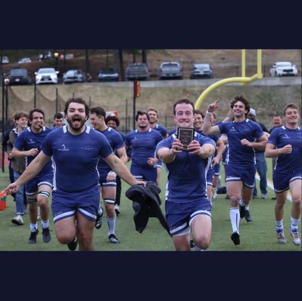 rugby huddle with mountain in back