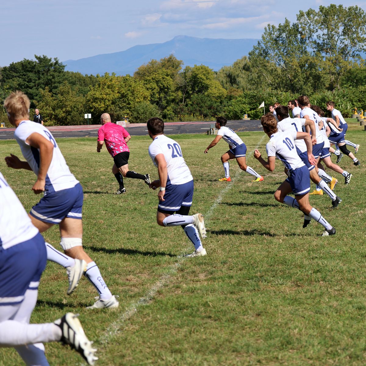 Rugby Huddle with Mountain 